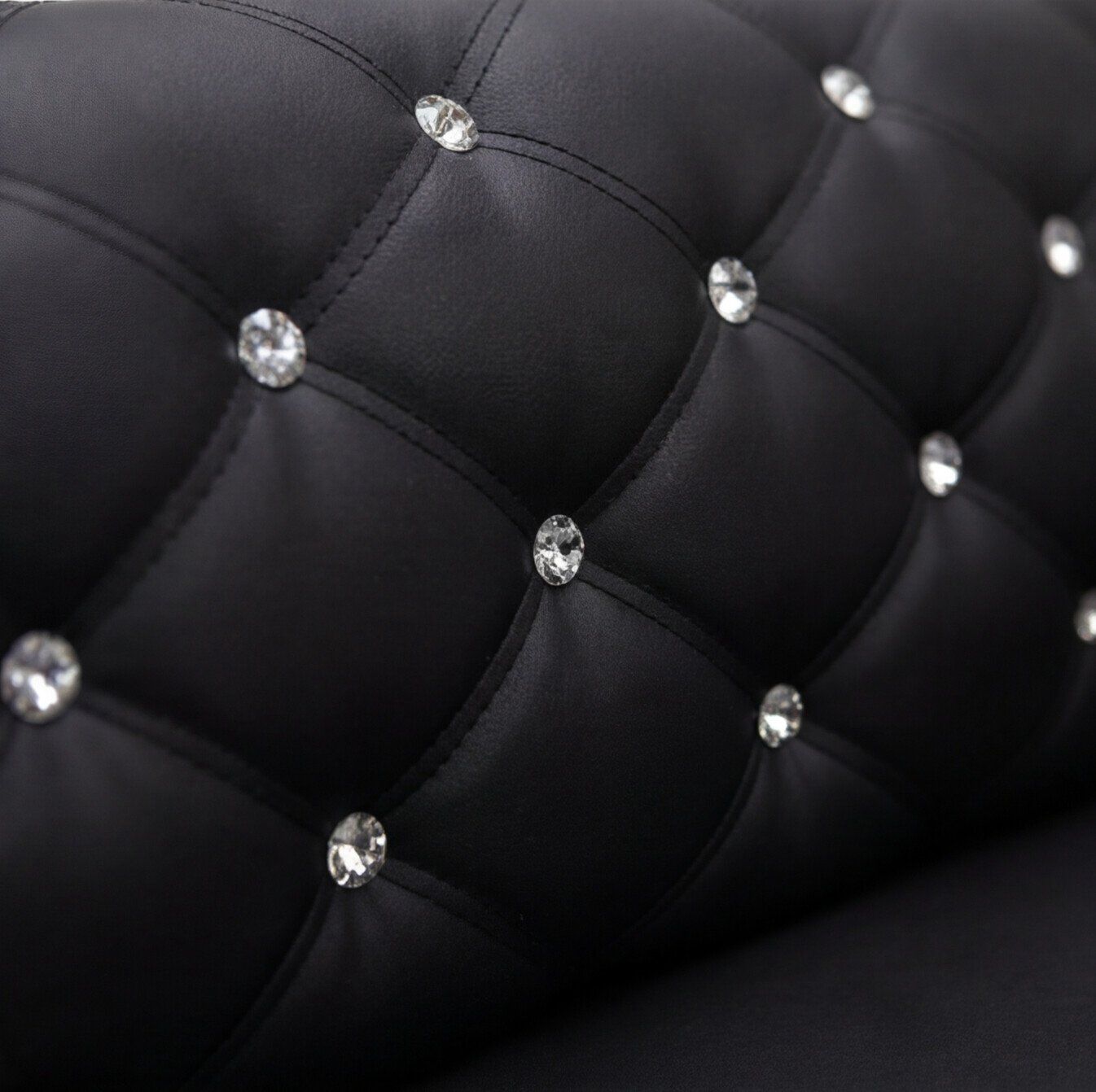 Detalle del tapizado en cordobán negro con capitoné diamante y botones cromados de cristal